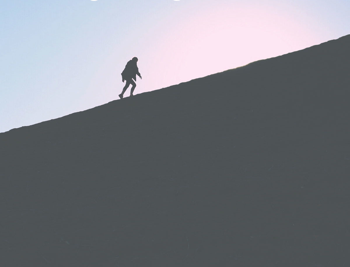 climber climbs mountain in shadow work