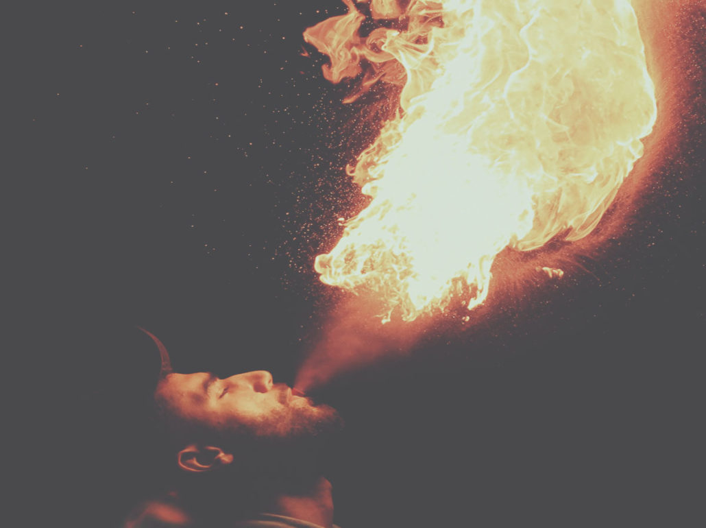 man breathing fire that blaze like inner demons