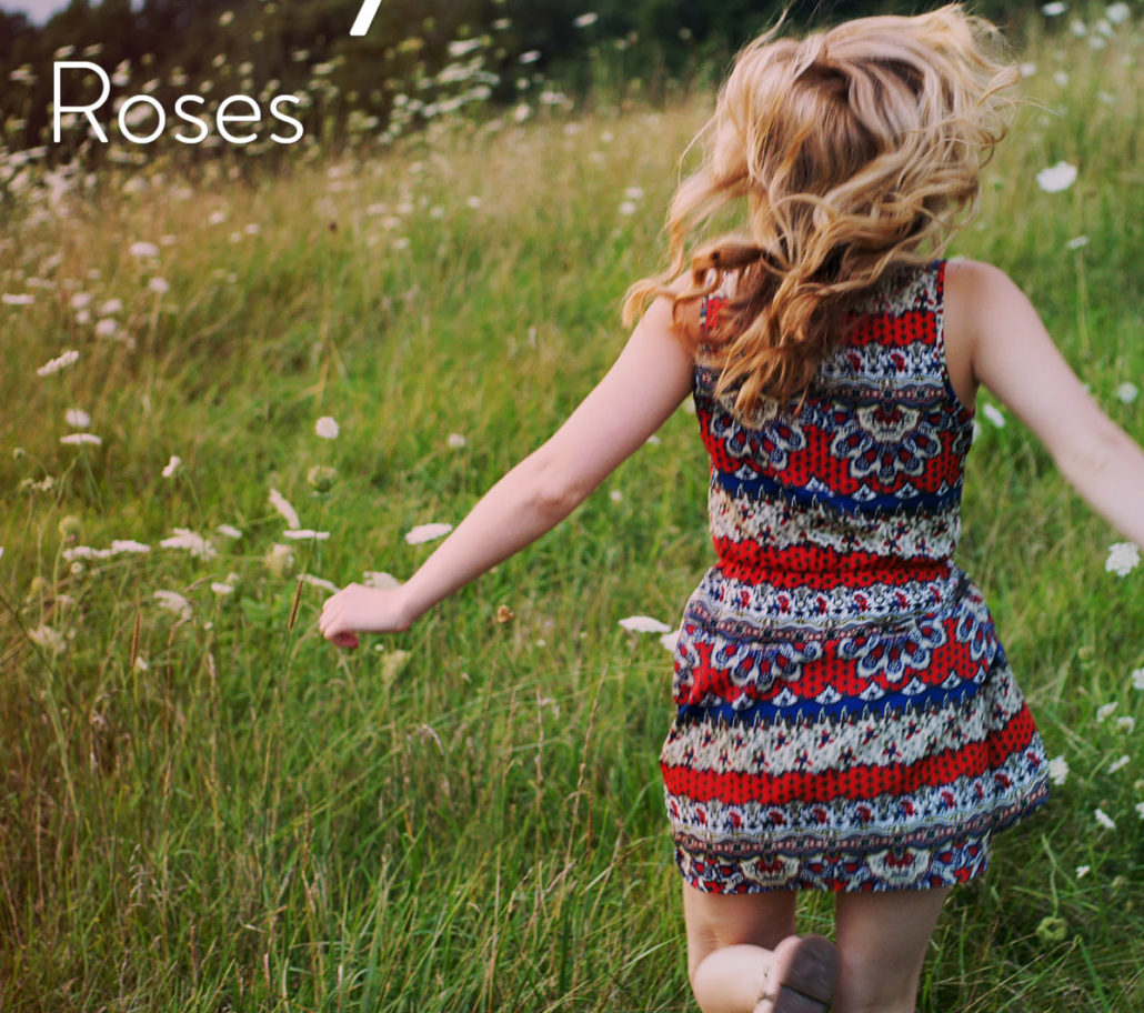 woman running through field to smell the roses