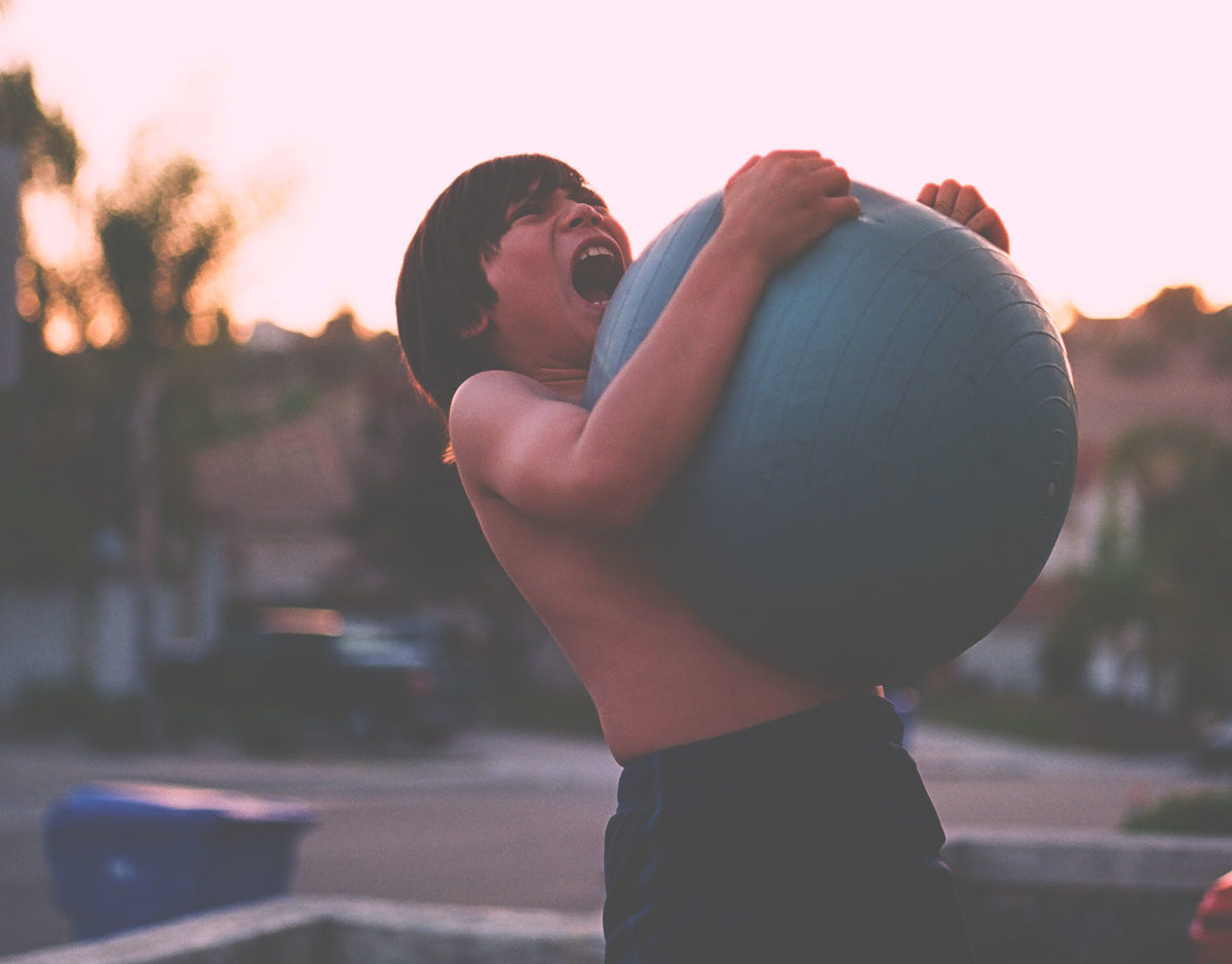 boy squeezing ball with pressure