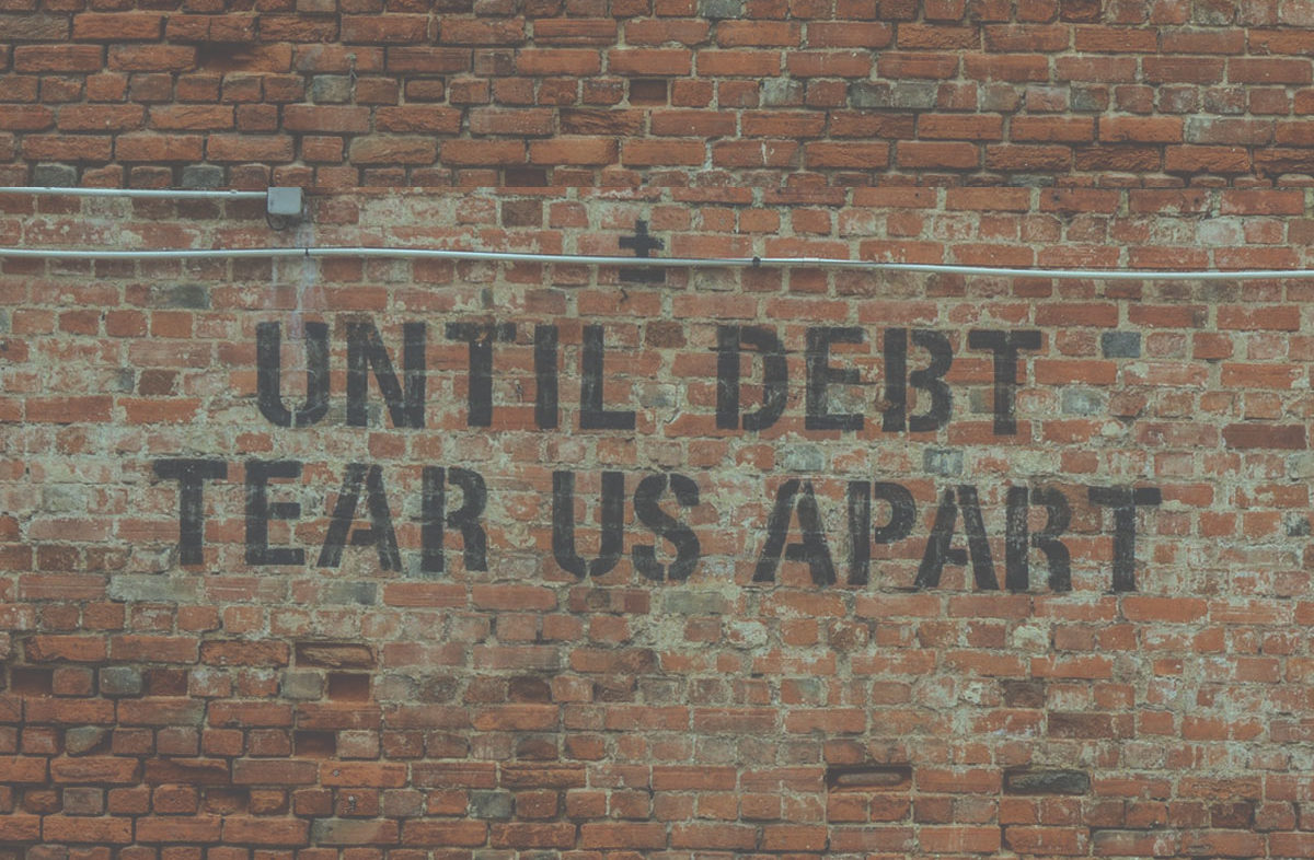 wall graffiti about debt the foundation of the guilt trip